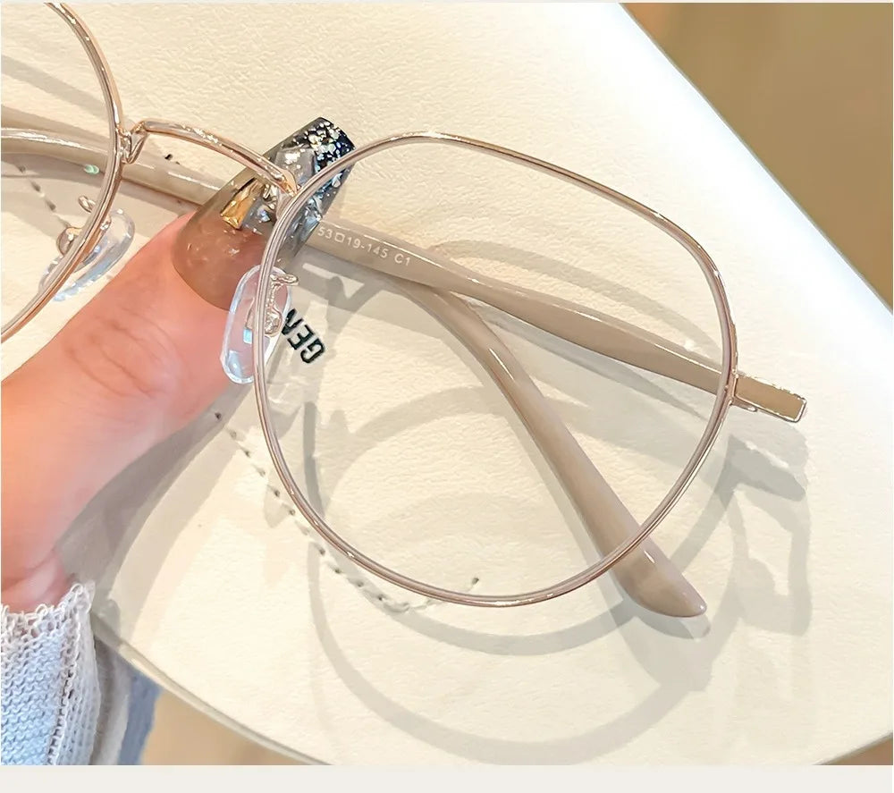 Clear Glasses for Women: Polygonal Metal Frame Eyeglasses with Flat Mirror Lenses, Designed for Girls, Featuring Anti-Blue Light Technology and Fashionable Eyewear Aesthetics.